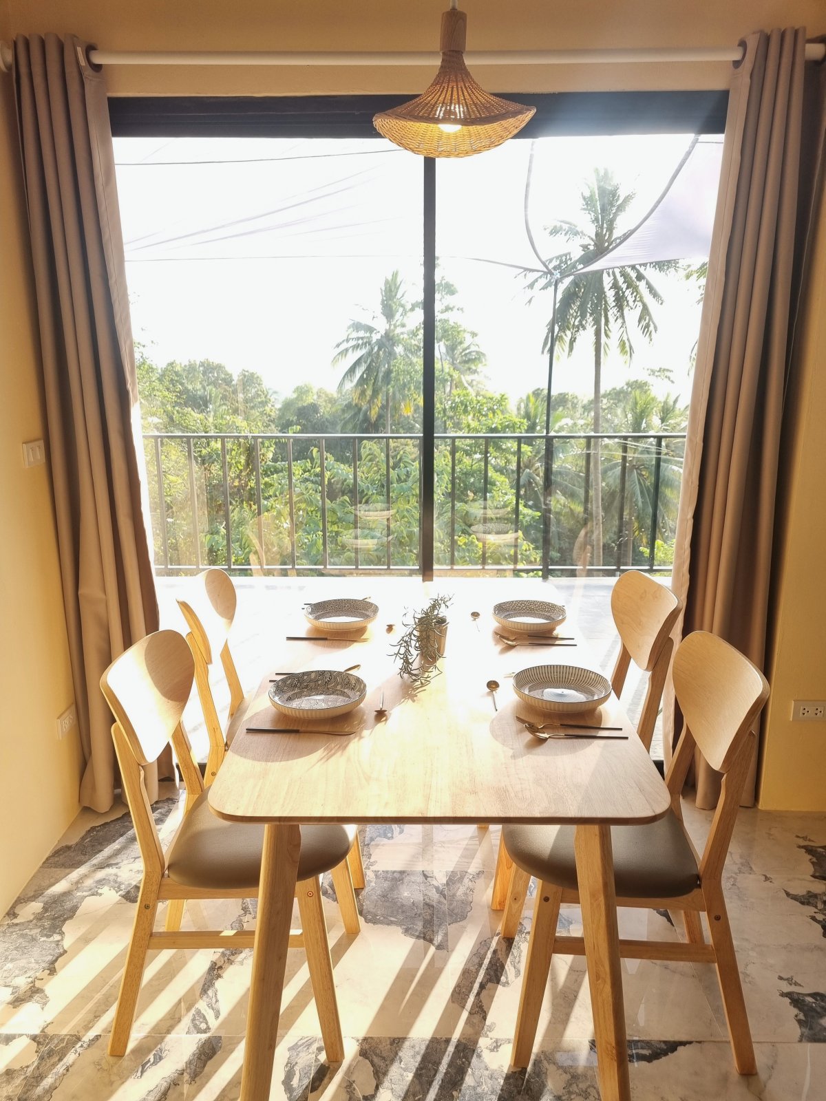 Dining table with palm-view balcony
