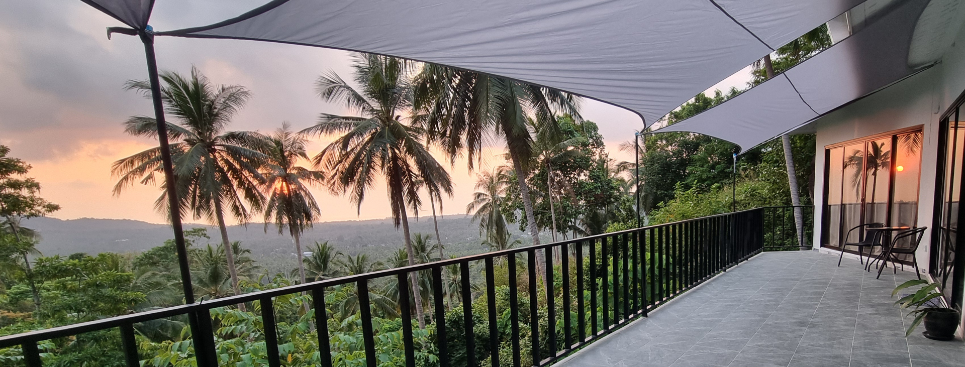 Terrace at sunset with palm trees